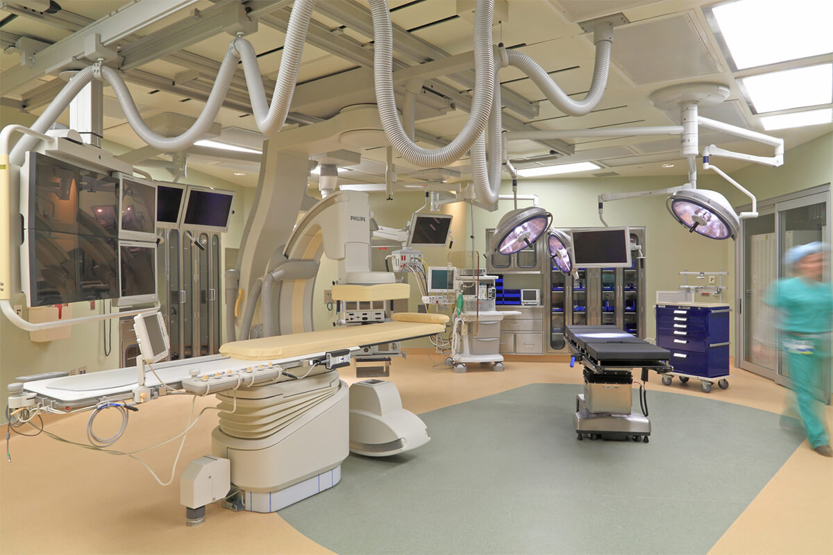 Interior view of a cardiovascular suite at Portsmouth Regional Hospital. The room features medical equipment and a medical procedure table.